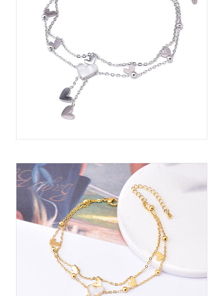 Tobillera de mujer con incrustaciones de acero y titanio con forma de corazón dulce