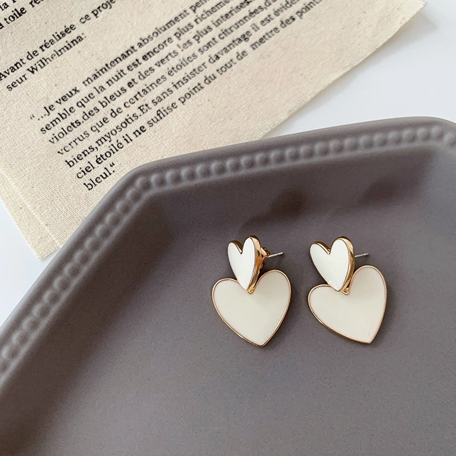 Pendientes colgantes de mujer esmaltados de aleación con forma de corazón lindo