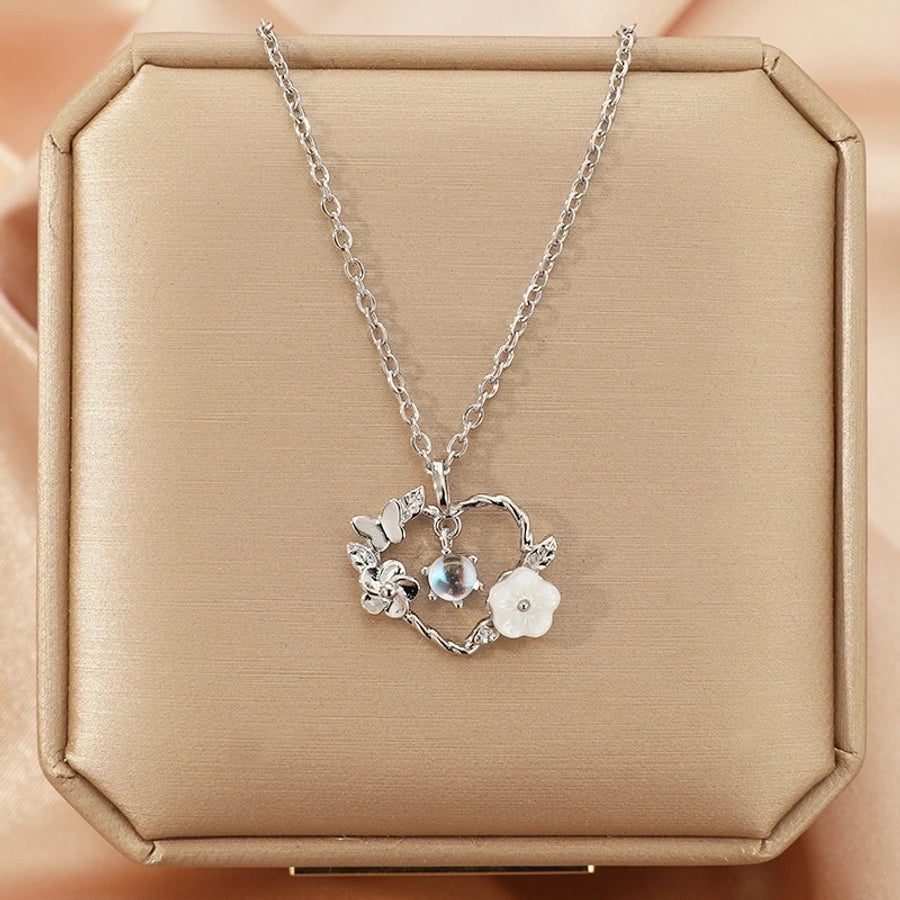 Collar con colgante chapado en oro con incrustaciones de acero de titanio y flor en forma de corazón