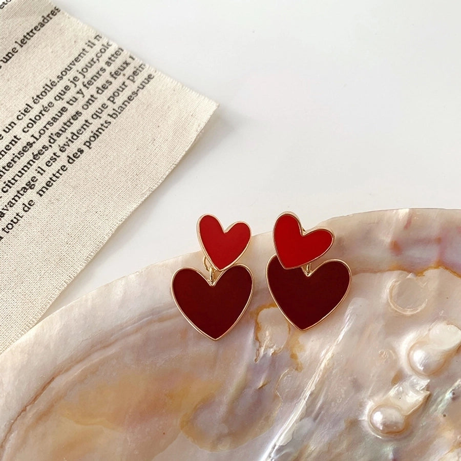 Pendientes colgantes de mujer esmaltados de aleación con forma de corazón lindo