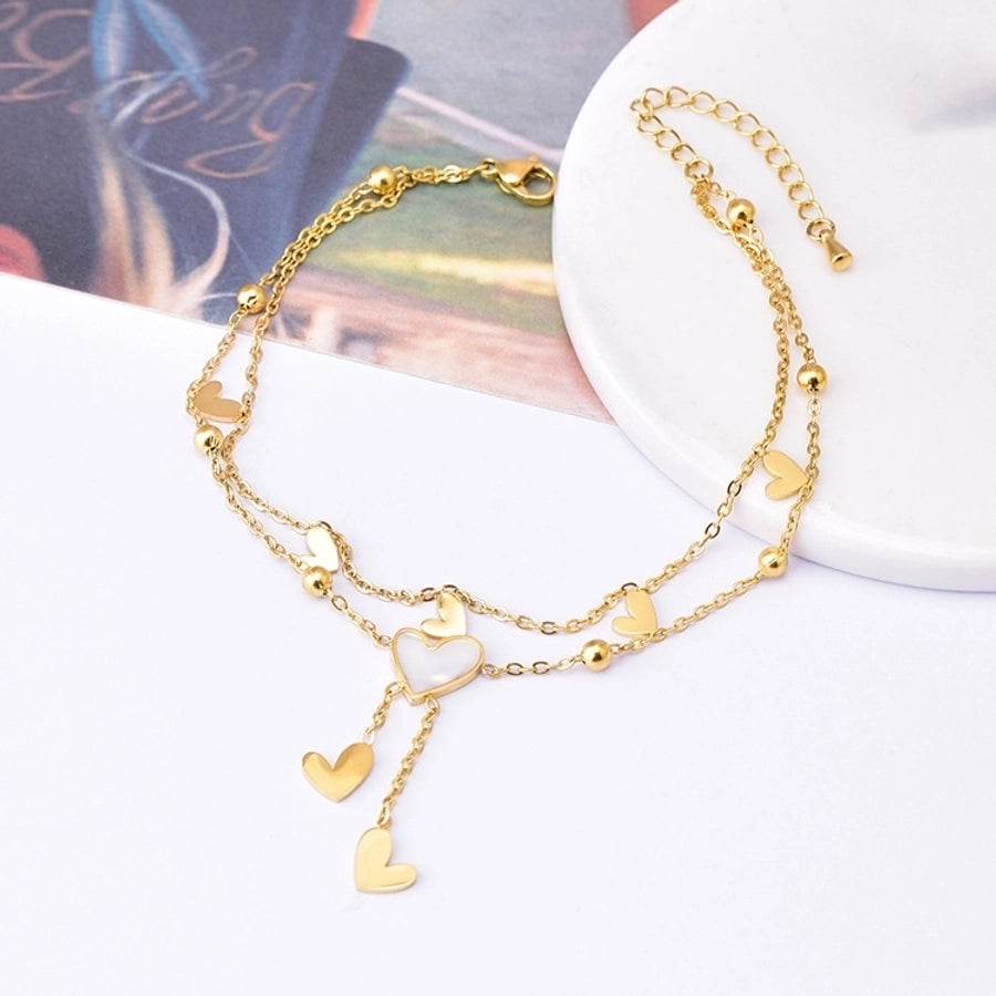 Tobillera de mujer con incrustaciones de acero y titanio con forma de corazón dulce