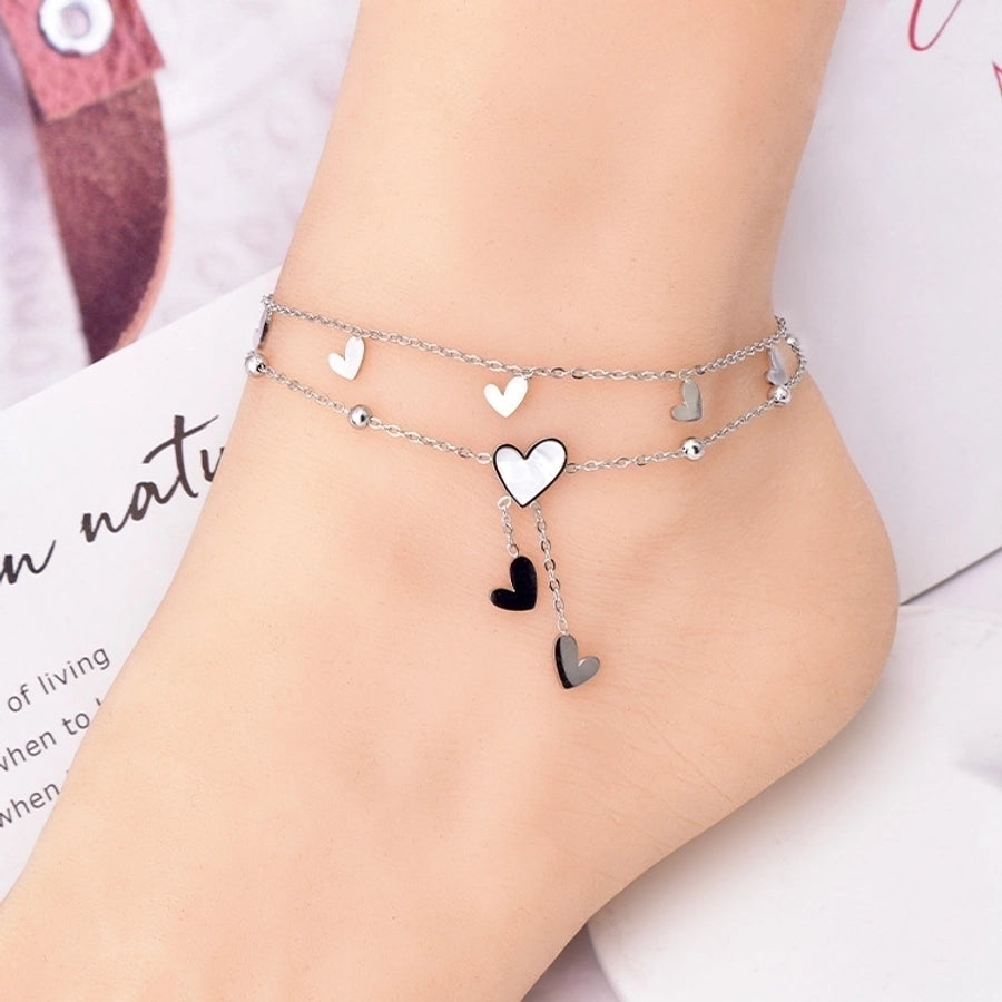 Tobillera de mujer con incrustaciones de acero y titanio con forma de corazón dulce