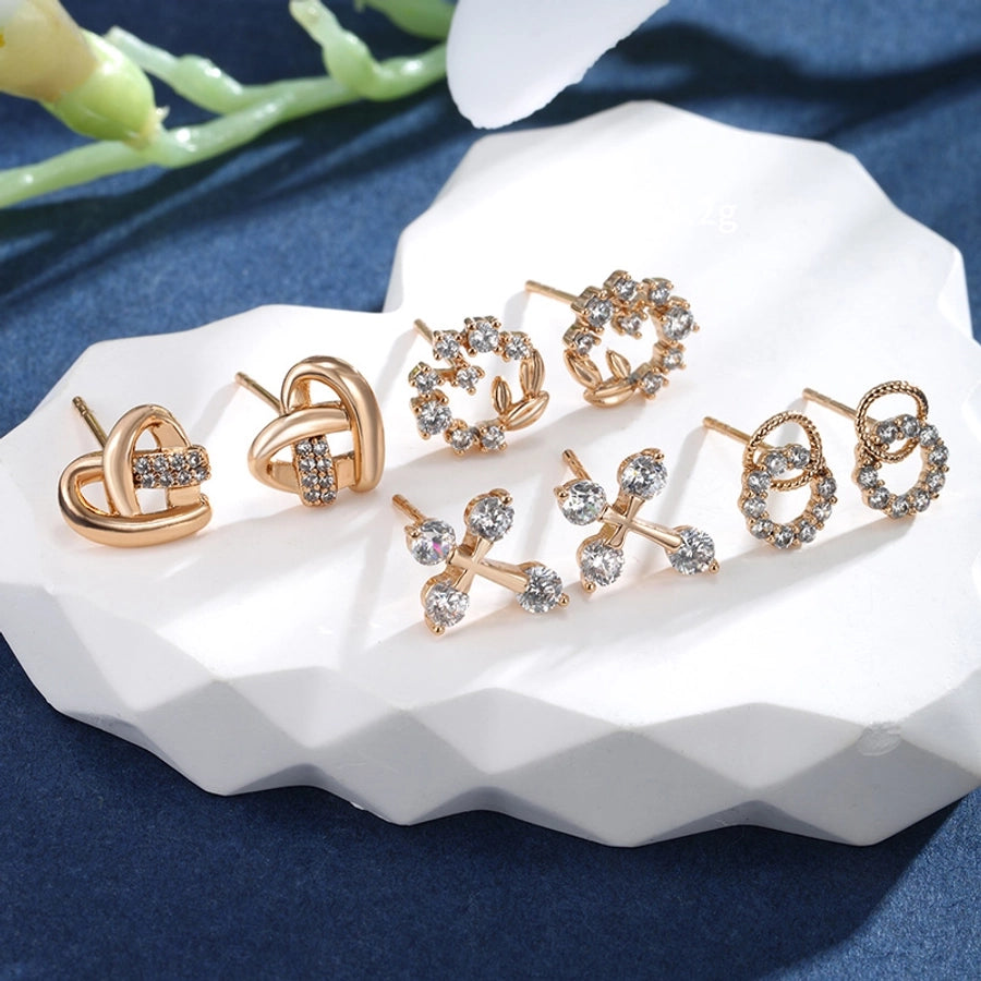 Pendientes de diamantes de imitación de aleación de cobre con incrustaciones de chapado en forma de corazón redondo cruzado elegante estilo de hadas